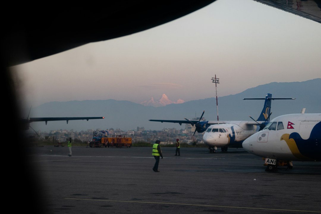 Aircraft on an airport runway in Nepal representing return migration and departure