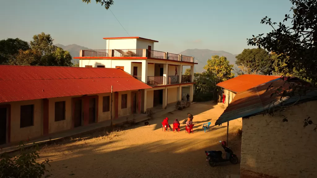 Children at a school courtyard in Nepal, illustrating the everyday lives of children whose parents may work abroad