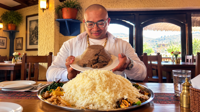 CMR presenting a large Nepali meal in a restaurant setting