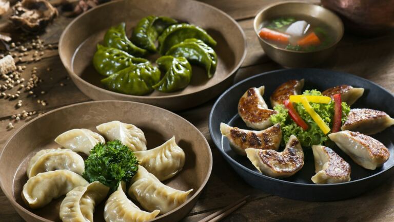 Bowls of momo dumplings illustrating food discovery; not a photograph of Mr Foodie Nepal