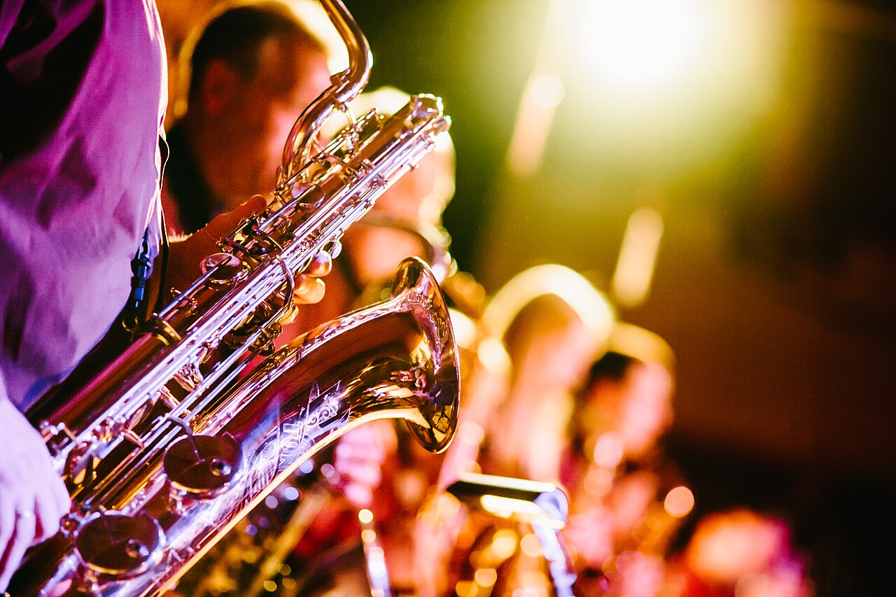 Close-up of a saxophone at a jazz performance with warm concert lighting