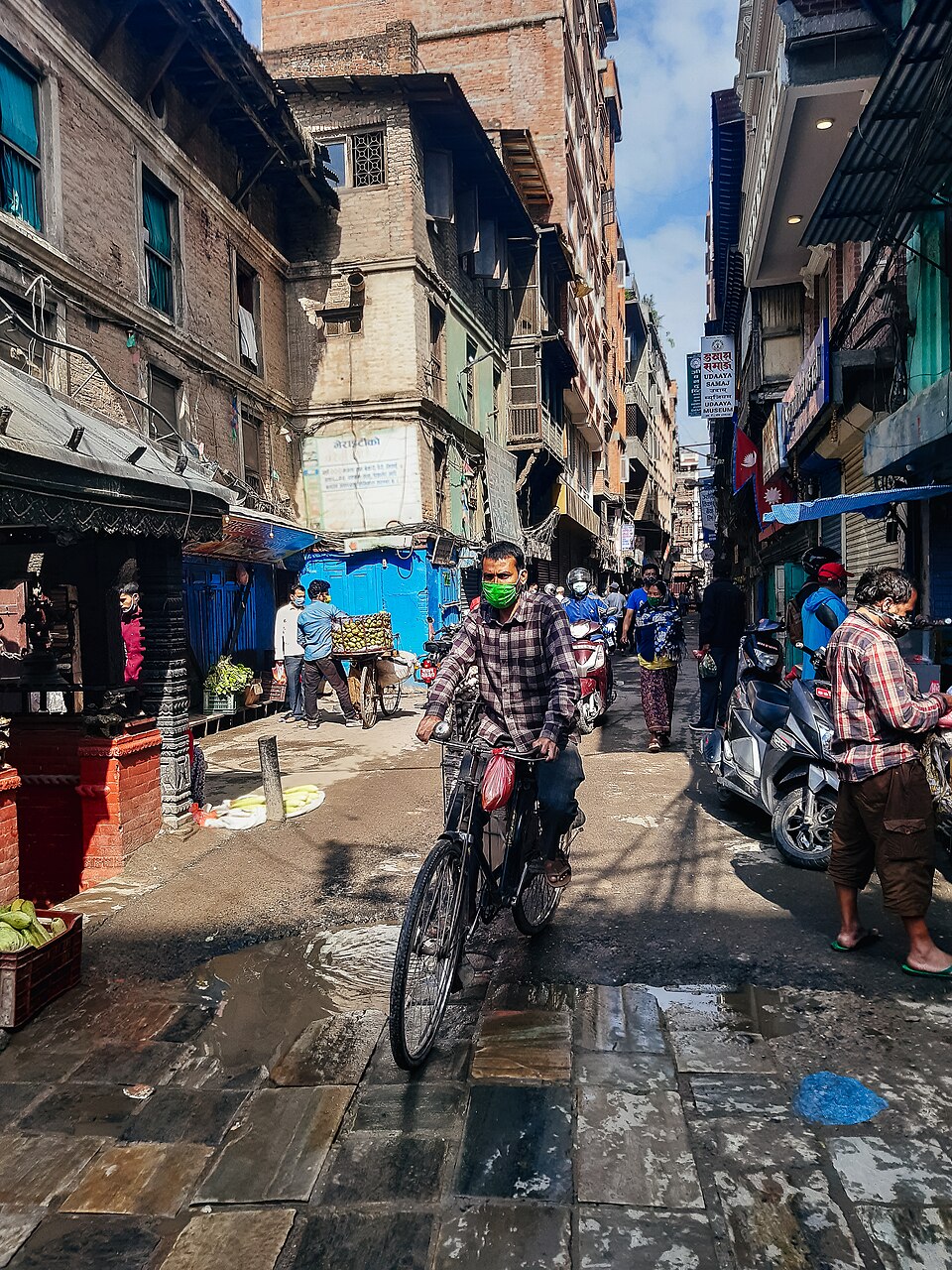 Person cycling down a lane in Ason Kathmandu Nepal