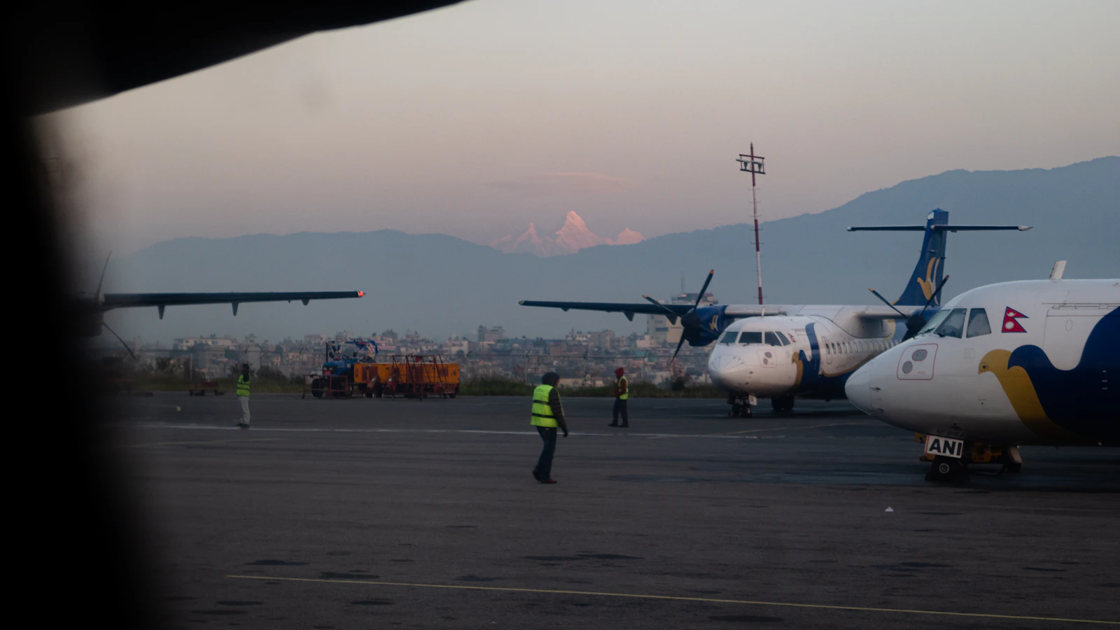 Aircraft on a runway in Kathmandu, representing diaspora travel home to Nepal