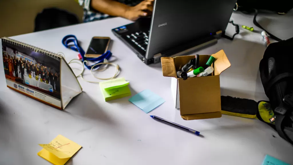 A laptop and project notes on a worktable, illustrating digital services and technology employment