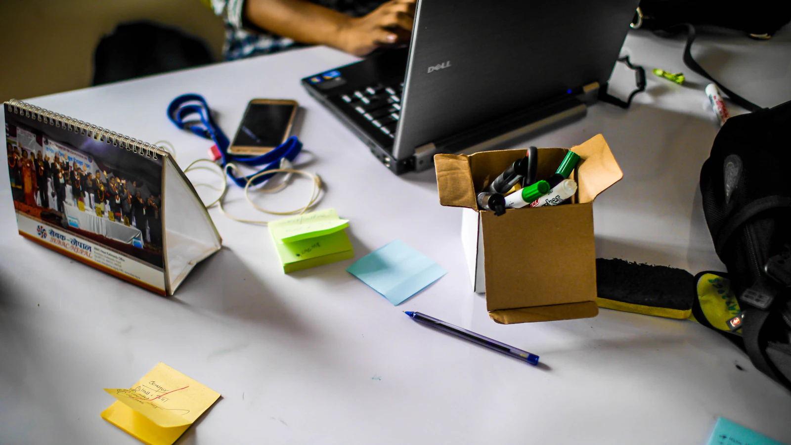A laptop and project notes on a worktable, illustrating digital services and technology employment