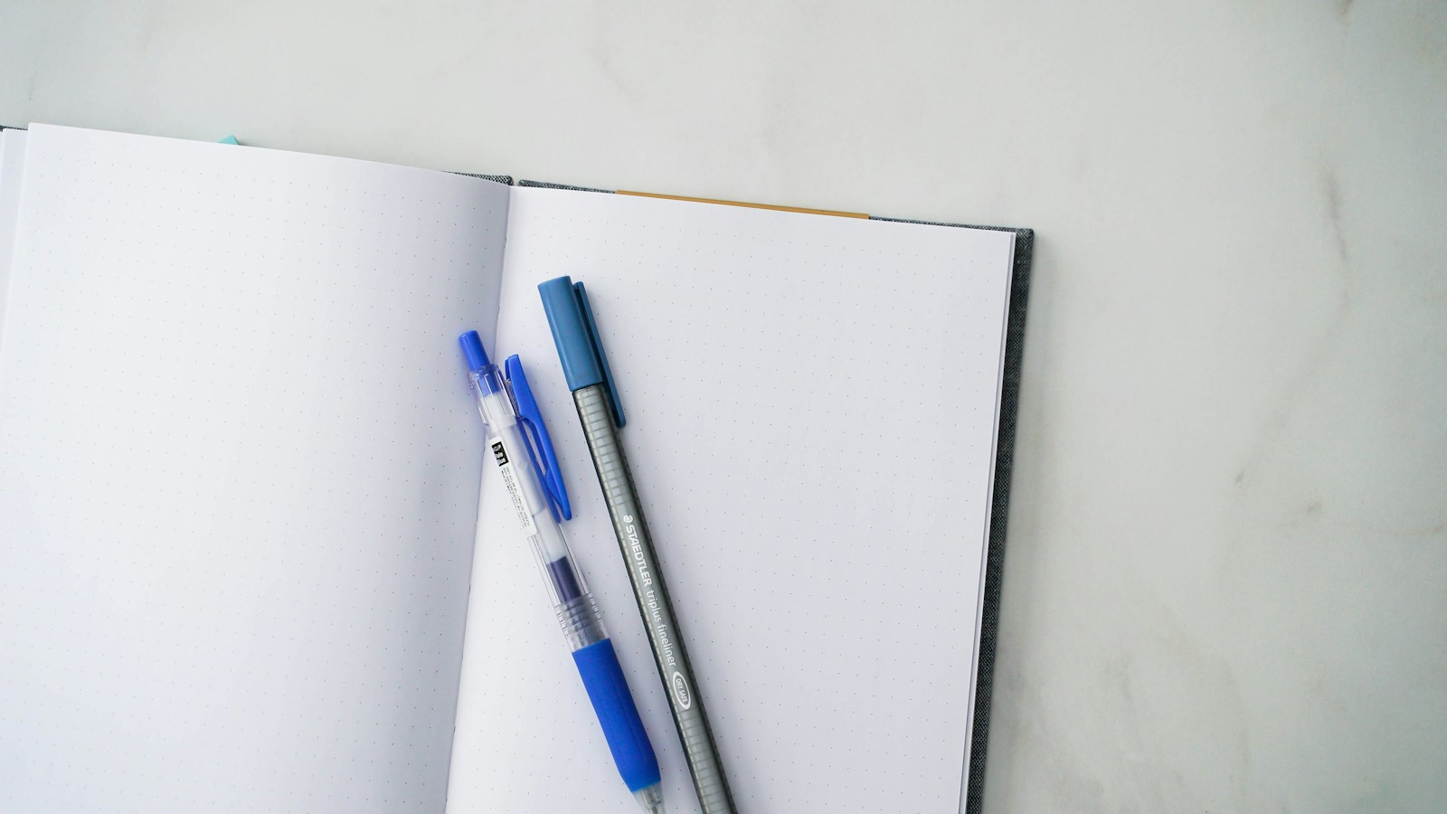 Notebooks and a pen on a desk, illustrating practical document preparation