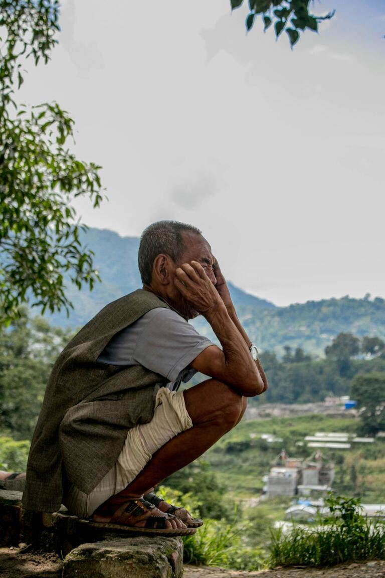 Person sitting outdoors representing mental health and emotional wellbeing