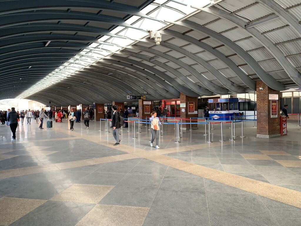 Travellers inside Tribhuvan International Airport in Kathmandu, representing the decision to leave or return to Nepal