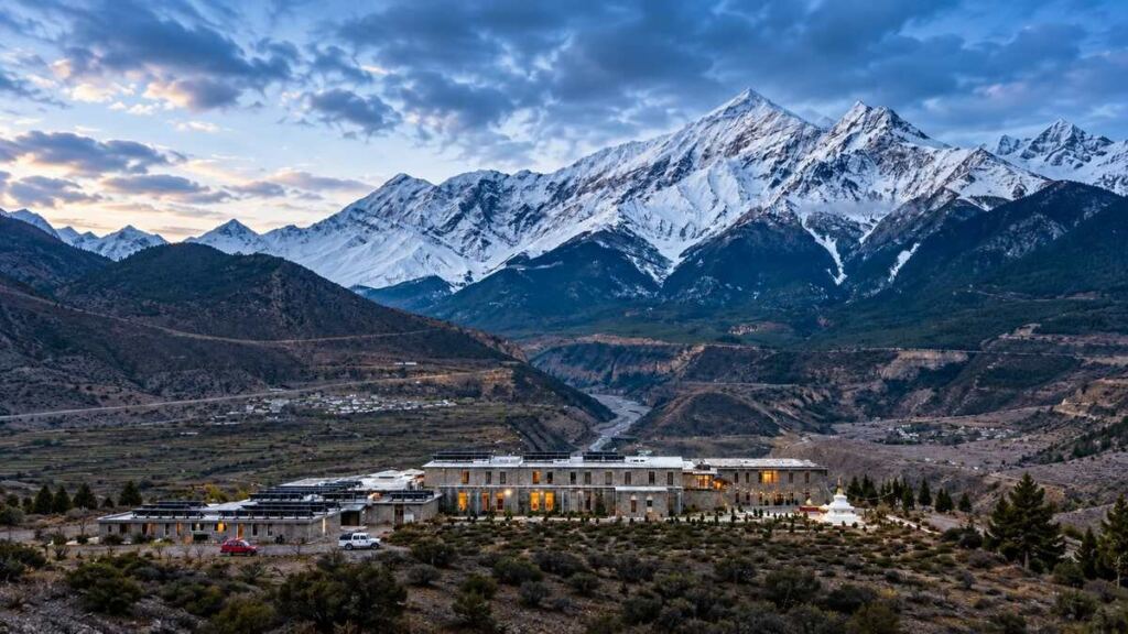 Shinta Mani Mustang hotel beneath snow-covered Himalayan peaks in Mustang, Nepal