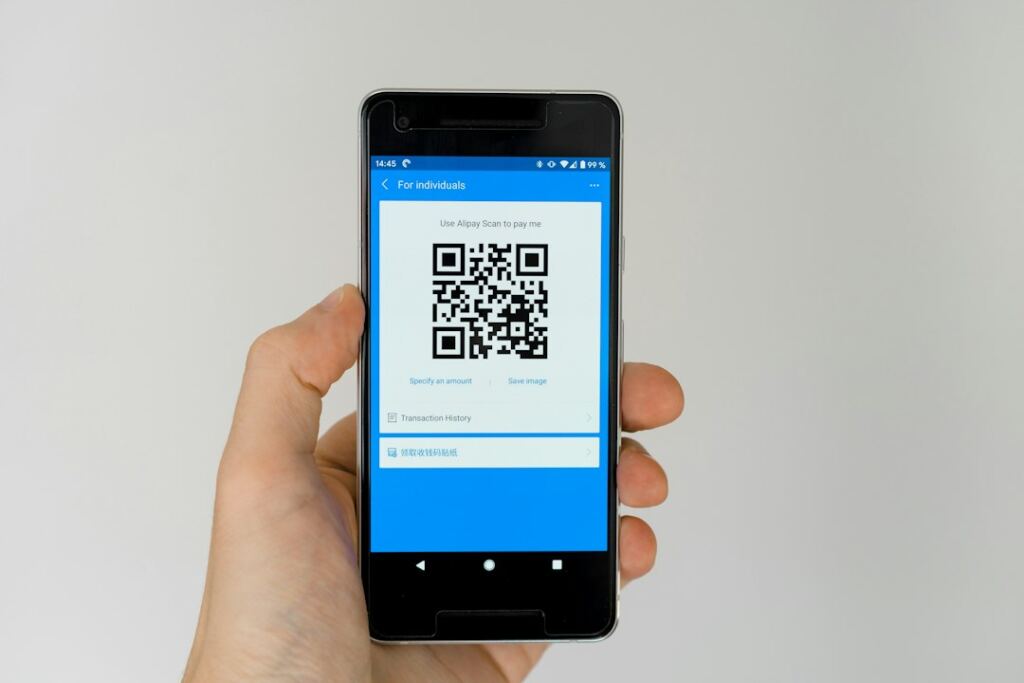 Smartphone displaying a QR code, illustrating mobile and QR payments used by small businesses