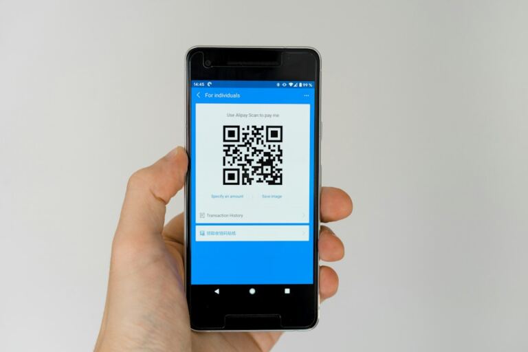 Smartphone displaying a QR code, illustrating mobile and QR payments used by small businesses