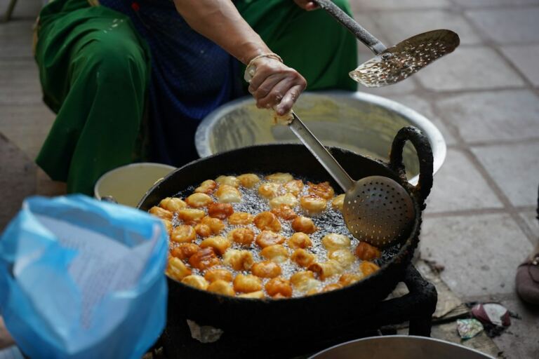Street food being prepared in Nepal, illustrating Kathmandu’s everyday food culture